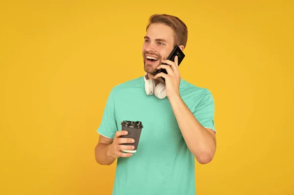 Cheerful Man Blue Shirt Speaking Smartphone Morning Coffee Yellow Background — Foto Stock