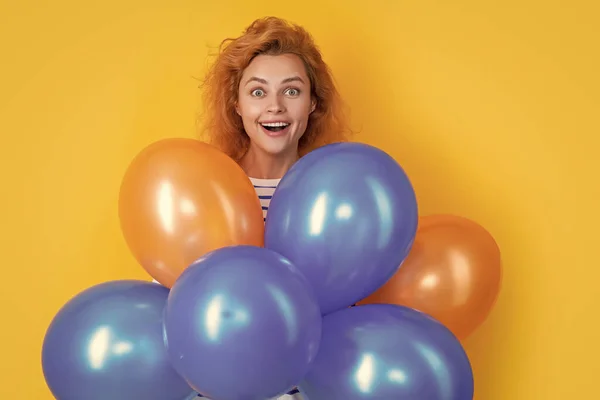 stock image surprised girl hold party balloons in studio. girl with balloon for party isolated on yellow background. party girl with balloon.