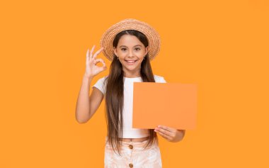 happy teen kid with copy space on orange paper on yellow background.