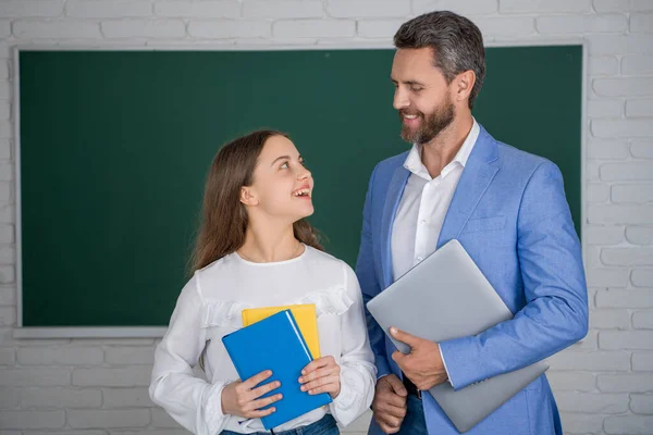 Cheerful Child Standing Blackboard Teacher Hold Laptop Workbook — Stock Photo, Image