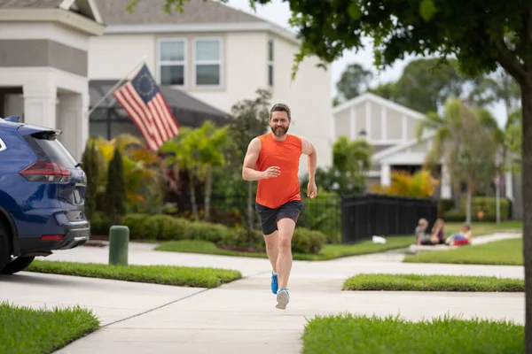 The running man enjoys freedom of running outdoor. running man feels sense of joy during the run. activity for a healthier you. sport fit man jogging outdoor. running man races down the neighbourhood.