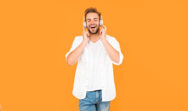 Yeni teknoloji. Modern kulaklıklı mutlu adam. Online eğitim. Okula dönüyorum. Kulaklıklı genç adam. Müzik aşığı. Müzik dinle. kablosuz aygıt aksesuarı.