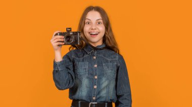 Happy surprise. Surprised kid holding camera. Looking with surprise. Its surprising. Wow. Omg.