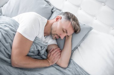 mature man napping in bed. early morning.