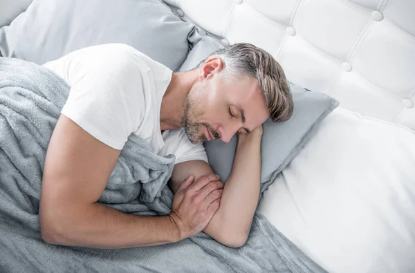 stock image mature man napping in bed. early morning.