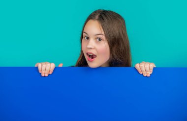 Boş mavi kağıdın arkasında, reklam için fotokopi alanı olan sürpriz çocuk..