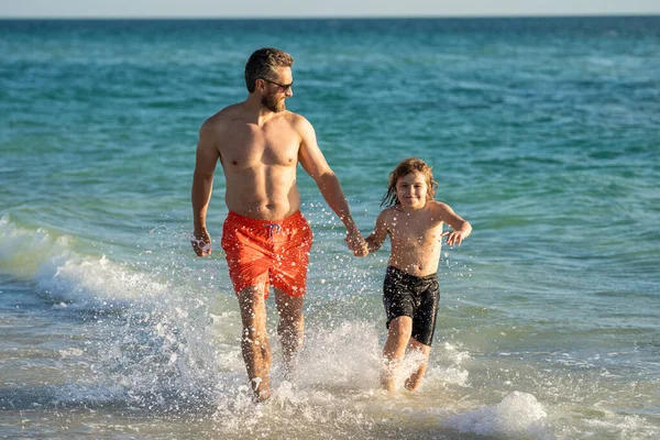 dad man and son kid running in sea beach. Fun and laughter. Father son bonding enjoying summer vacation. Special moments between dad and son child at sea. Father son adventures.