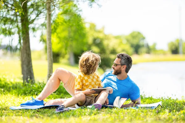 childhood school education. son with daddy bonding in summer. family education of daddy and son child. daddy inspire educational journey of his son kid. daddy and son relax in park. lessons in nature.