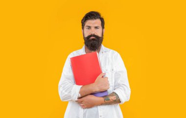 Arkaplanda planlayıcısı olan bin yıllık bir adam. Milenyum adamı ve planlayıcısının fotoğrafı. Milenyum adamı planlayıcısı sarı renkte izole edilmiş. Stüdyoda planlayıcısı olan bin yıllık bir adam..