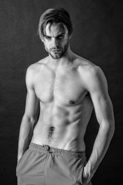 adult man with muscular abs in studio. muscular man with abs muscles. photo of man with muscular abs. muscular man with abs isolated on black background.