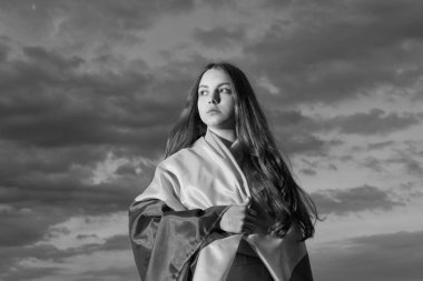 patriotic teen ukrainian kid with national flag of ukraine.