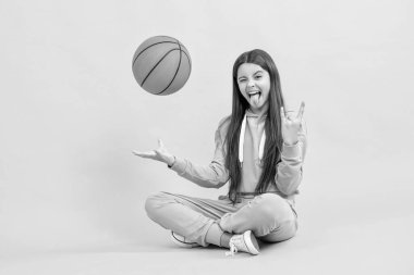 cool teen basketball girl in studio. teen basketball girl on background. photo of teen basketball girl with ball. teen basketball girl isolated on yellow.