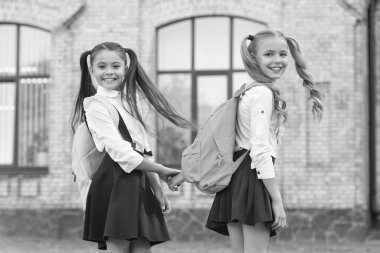 happy two school girls best friends together outdoor.