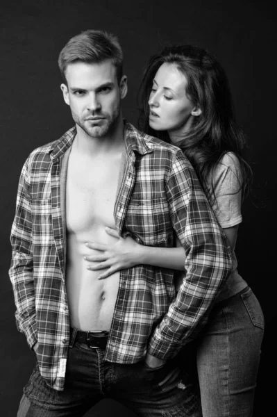 sexy young couple in love in shirt on black background, relationship.