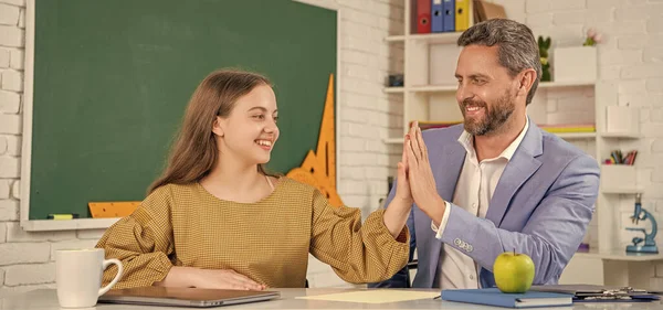 stock image happy kid study in classroom with tutor.
