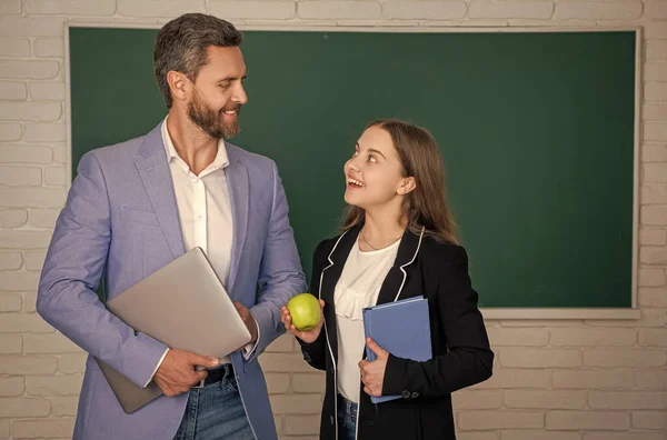 stock image positive girl with man teacher in classroom. education.