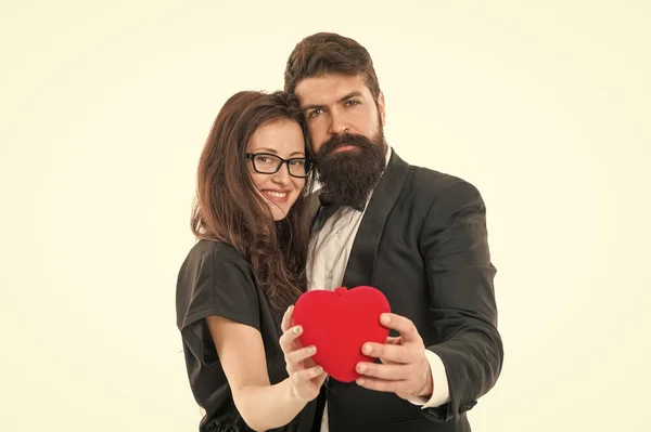 big heart. formal couple in love hold heart. engagement. elegant couple formal event. love and romance. romantic date for man and woman. happy valentines day. tuxedo man beard and girl in glasses.