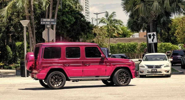 Miami Beach, Florida USA - April 15, 2021: pink metallic mercedes g63 AMG by impressive wrap, side view.