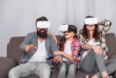 modern life. father mother and child VR glasses. virtual reality family. happy parents with kid girl use modern technology. mom dad and daughter. digital future and innovation.