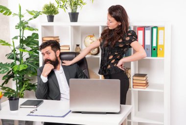 Woman boss touching and harassing man secretary working in office, harassment. clipart