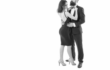 Pleased with each other. woman fix bow at males tuxedo. brutal man embrace his lady. couple in love. business meeting and partnership. love and romance. formal couple grooming for formal event.