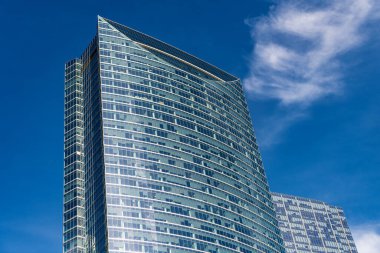 Gökdelen mimarisi. Camsı yüzlü bir gökdelen. Modern cam bina. Metropolis City 'de bir gökdelen. Şehir merkezinde gökdelenli bir şehir. Ofis inşaatı metropol mimarisi.