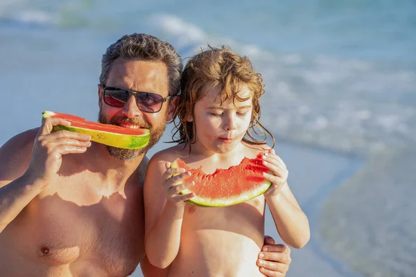daddy dad and son on summer vacation. single dad with son at beach. being together. dad father and son kid enjoying quality time together at sea. dad and son hold healthy watermelon. family support.