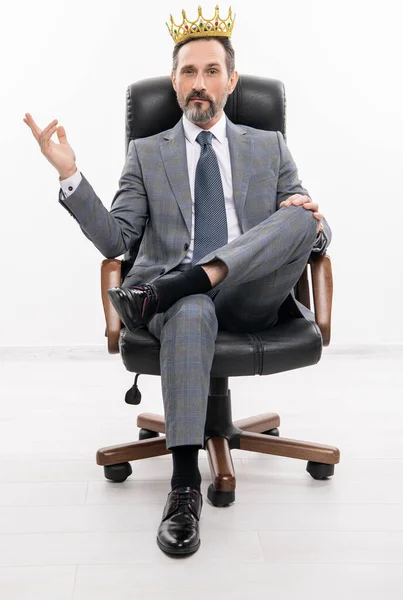 successful businessman leader in office chair. motivation and reward. selfish businessman boss in suit. leadership concept. business leader man in crown. big boss. business success and leadership.