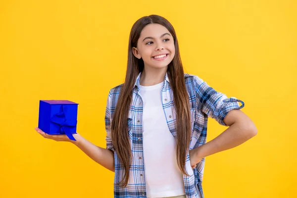 happy teen girl show present on a special occasion. teen girl with present. teen girl holding present box with excitement at birthday party. teen girl with present. childhood happiness.