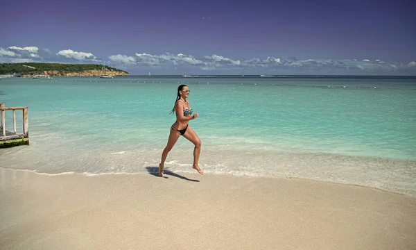 photo of woman running on summer vacation. woman running on summer vacation at beach. woman running on summer vacation outdoor. woman running on summer vacation holidays.