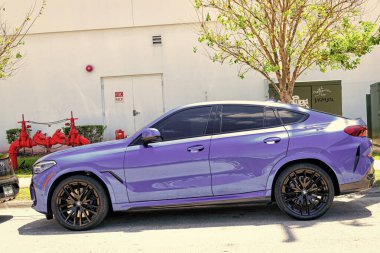 Miami Beach, Florida USA - April 15, 2021: parked blue bmw x6 sdrive 40i, side view.