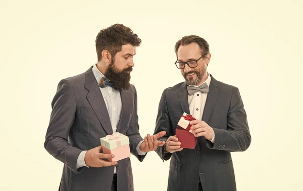Business people celebrate holiday. Corporate party concept. Hipster bearded bought gifts. Holiday shopping. Buy gifts. Prepared something special. Guests on wedding party. Men classic suit hold gifts.