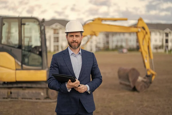 stock image supervisor with business project, copy space. supervisor check business project at site. supervisor checking business project outdoor. photo of supervisor with business project in hardhat.