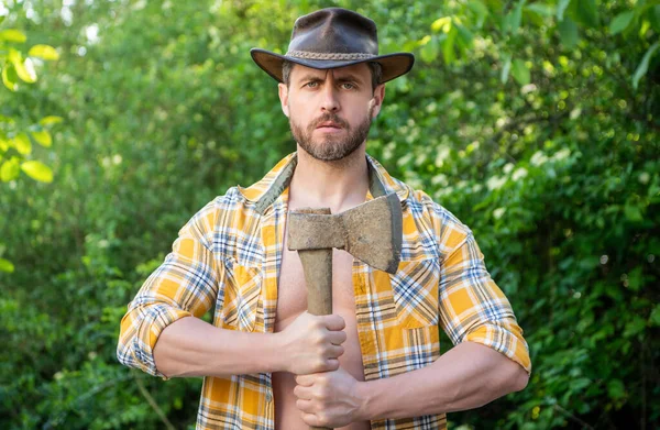 stock image bearded lumberjack with axe wearing checkered shirt. lumberjack with axe outdoor. photo of lumberjack with axe. lumberjack with axe.