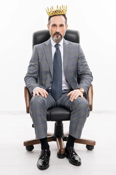 leadership concept. business leader man in crown. big boss. business success and leadership. successful businessman leader in office chair. motivation and reward. businessman boss in suit.