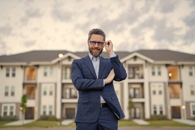 Neşeli bir emlakçının fotoğrafı. Evdeki erkek emlakçı. Takım elbiseli bir emlakçı. Erkek emlakçı..