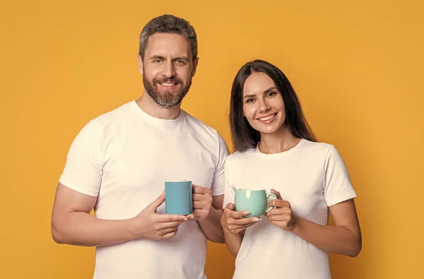 Couple of guy and girl drinking morning coffee. Happy couple enjoying coffee in morning studio. Morning drink. Good morning.
