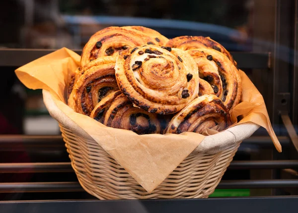 bakery food. fresh baked cinnabon. french croissant pastry. fresh bakery. cinnabon croissant in basket. baked food. breakfast in cafe with cinnabon or croissant.