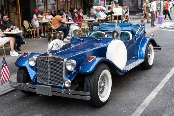 New York City, USA - June 30, 2023: Excalibur Series III phaeton car front driver side view parked.