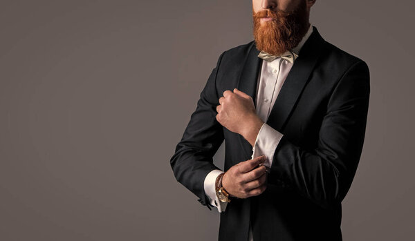 bearded man in tuxedo formalwear isolated on grey background. cropped view with copy space. man studio shot in tuxedo formalwear. man wearing tuxedo formalwear.
