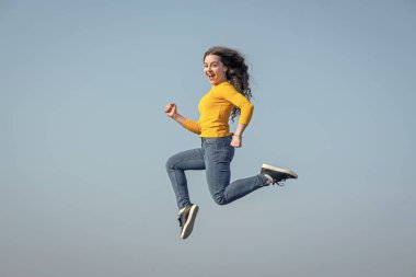 happy teen girl jump high on sky background. motivation.