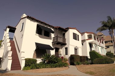 House in suburb. Private residence surrounded by picket fence. Suburban architecture.