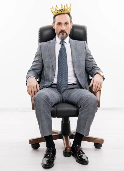 business leader man in crown. big boss. business success and leadership. successful businessman leader in chair. motivation and reward. businessman boss in suit. leadership concept. entrepreneur.