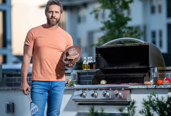 man grilling his favorite meats, copy space. Grill virtuoso flavor. cook showcasing his barbecue techniques at cookout event. Man enjoying barbecuing.