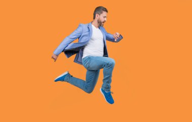 man rushing isolated on yellow studio background. man hurry to meet deadline. concept of deadline.