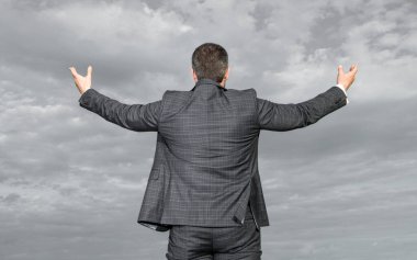 back view of successful business man in suit. photo of successful business man in suit. successful business man in suit on sky background. successful business man in suit outdoor.