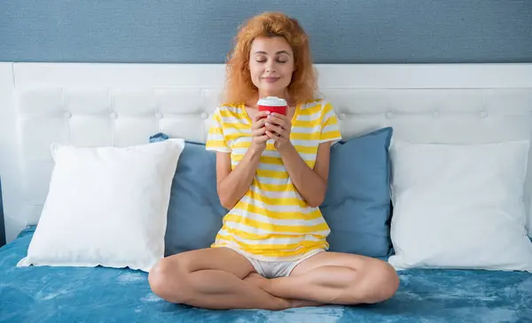 woman smelling morning coffee in bed. good morning. woman with coffee cup. woman hold coffee in the morning.