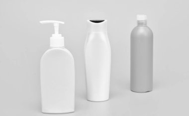 Beauty packaging. Cosmetic bottles yellow background. Toiletry bottles in row. Shower and bath gel packaging. Liquid containers. For bodywash products, copy space.