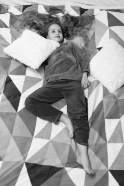 childhood of teen girl relax in bed, full length. childhood of teen girl relax in bedroom. childhood of teen girl relax wearing pajama. childhood of teen girl relax.