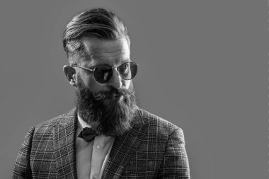 bearded tuxedo formal man in studio. tuxedo formal man on background. photo of tuxedo formal man with beard. tuxedo formal man isolated on grey.